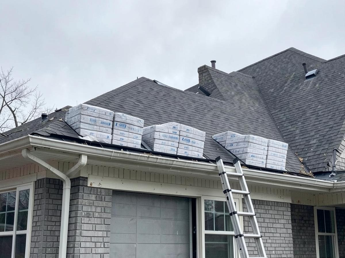 Sample photograph of shingle bundles stacked on a residential roof during a replacement